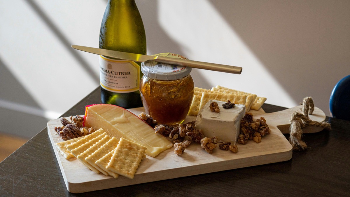 A chilled bottle of wine with a cheese pairing